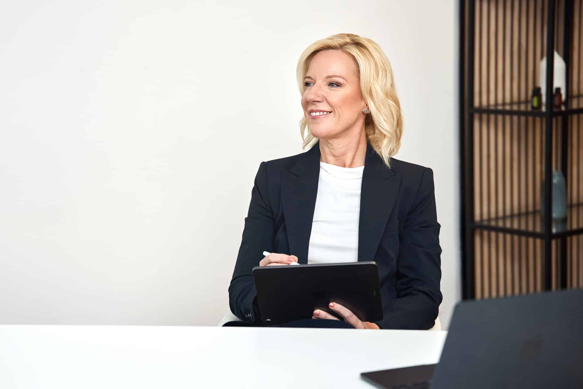 Bettina Buttkus entpannt auf dem Sofa sitzend.